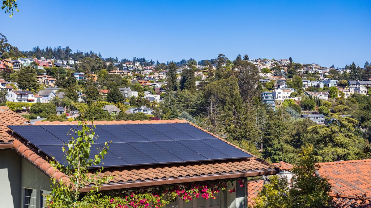 A rooftop 3kW solar array of black monocrystalline panels on a tiled roof