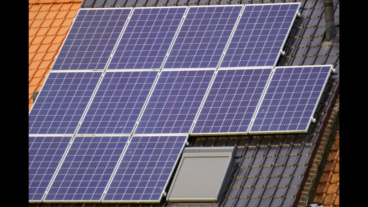 Polycrystalline solar panels installed on a tiled roof, showing the cell grid and aluminium frames